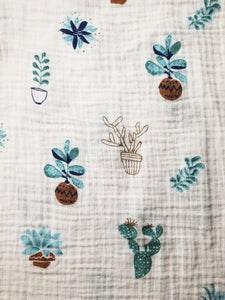 Blue succulent and cactus print cotton muslin baby blanket 2 pack with travel bag. Zipper closure and water resistant lining. 100% cotton muslin natural fibers. Blue print. 